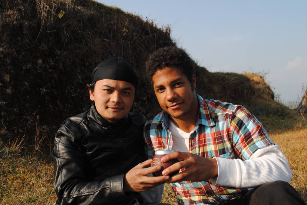Two new friends sharing a gourd of Yerba Mate in Nepal