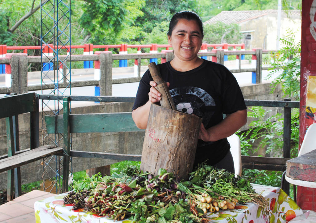 A woman with some of the medicinal herbs added to tereré